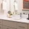 Model bathroom at our apartments in Washington DC, featuring white counters and stainless steel faucet. 