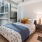 Spacious bedroom with wood-like flooring and beautiful windows 