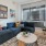 Model living room at our apartments in Washington DC, featuring wood grain floor panels and a blue couch. 