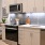 Model kitchen at our apartments in Washington DC, featuring white counters and stainless steel appliances. 