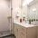 Model bathroom at our apartments in Washington DC, featuring white counters and stainless steel faucet. 