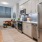 Model kitchen at our apartments in Washington DC, featuring wooden bench seating and stainless steel appliances. 