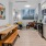 Model kitchen at our apartments in Washington DC, featuring wooden bench seating and stainless steel appliances. 