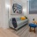 Spacious living room with wood-like floors and unique windows