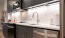 kitchen detail charcoal cabinets and white herringbone backsplash